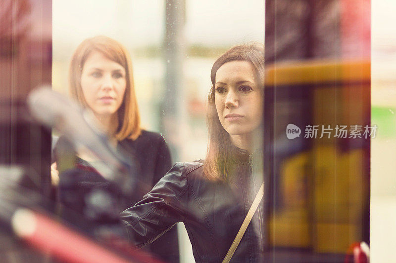 Young women waiting on the bus station